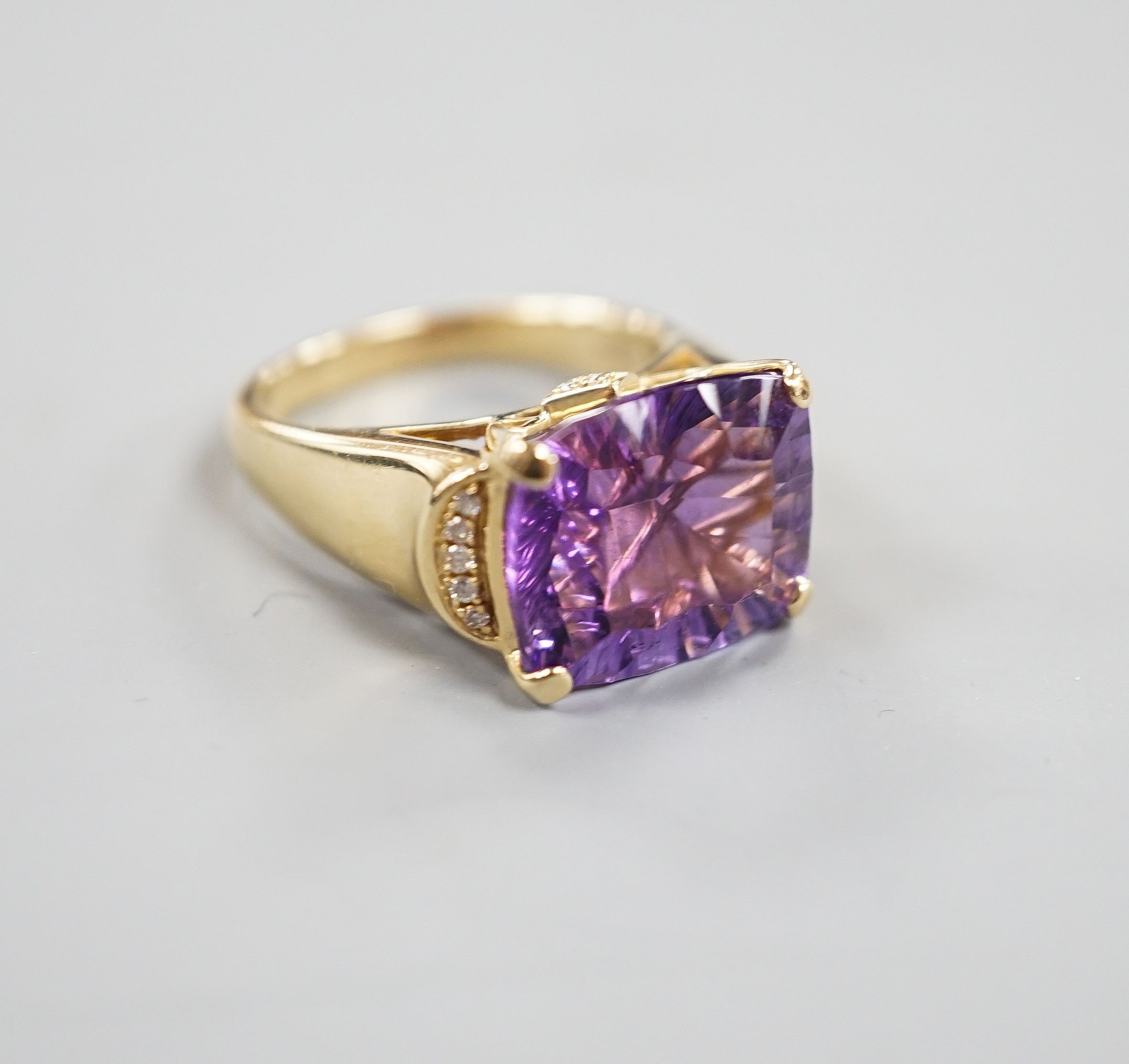 A modern 14k yellow metal, fancy cut amethyst and diamond chip set dress ring, size P/Q, gross weight 8 grams.